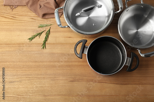 Flat lay composition with clean cookware and space for text on wooden background