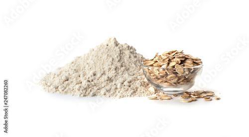 Bowl with oat flakes and flour isolated on white