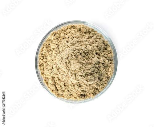 Bowl of fresh pumpkin seed flour isolated on white, top view