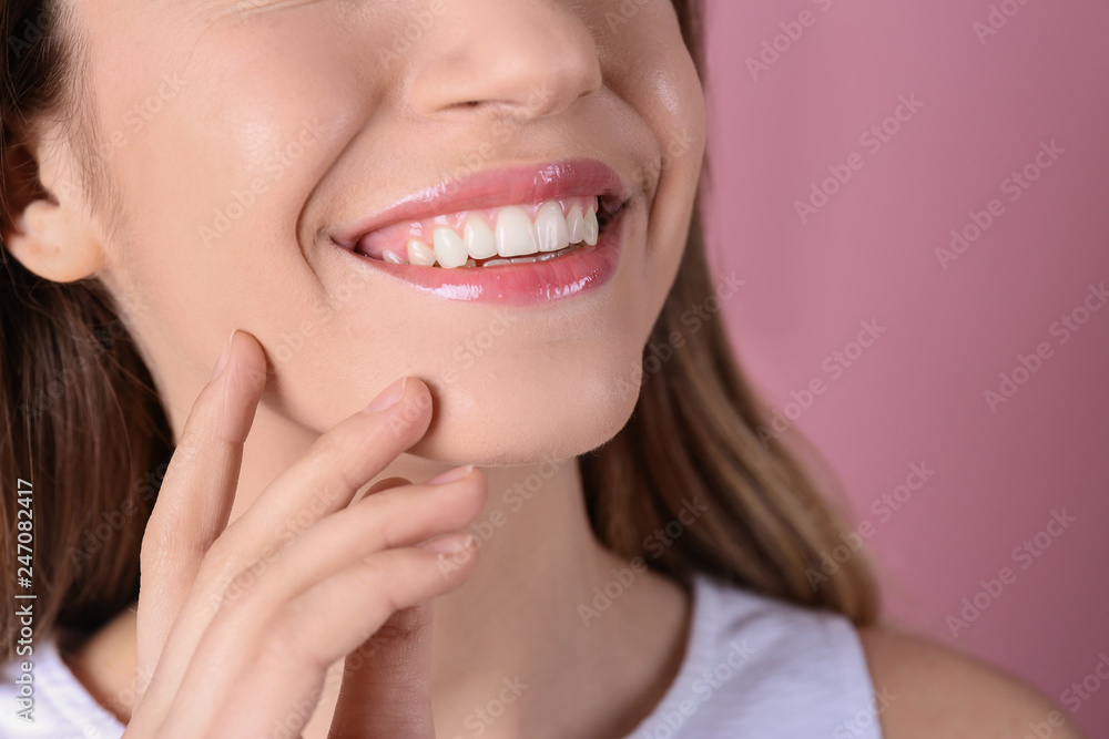 Young woman with healthy teeth and beautiful smile on color background, closeup Young woman with healthy teeth and beautiful smile on color background, closeup