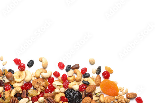 Different dried fruits and nuts on white background, top view. Space for text