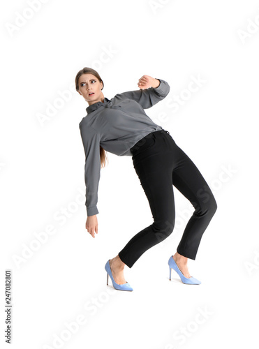 Young woman attracted to magnet on white background