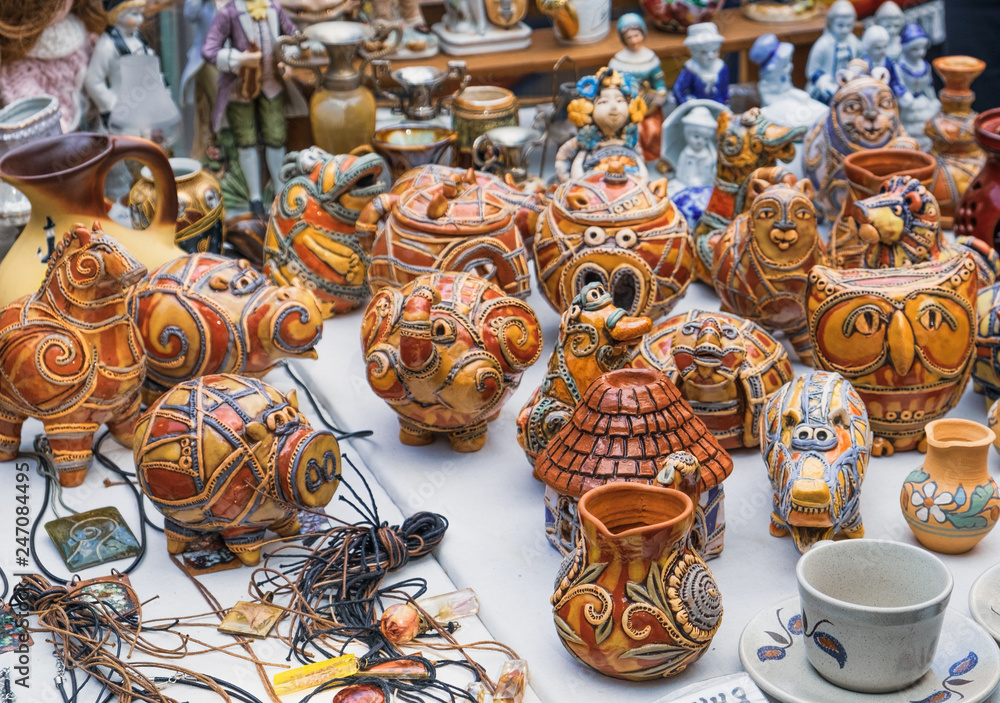 Souvenirs for tourists shopping in souvenir shop of Old Town, Lviv, Ukraine. Handmade clay piggy banks, toys, cups in memory of the journey