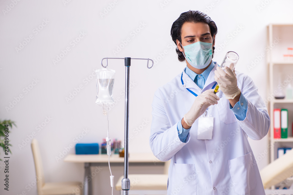 Young male doctor in blood transfusion concept Young male doctor in blood transfusion concept