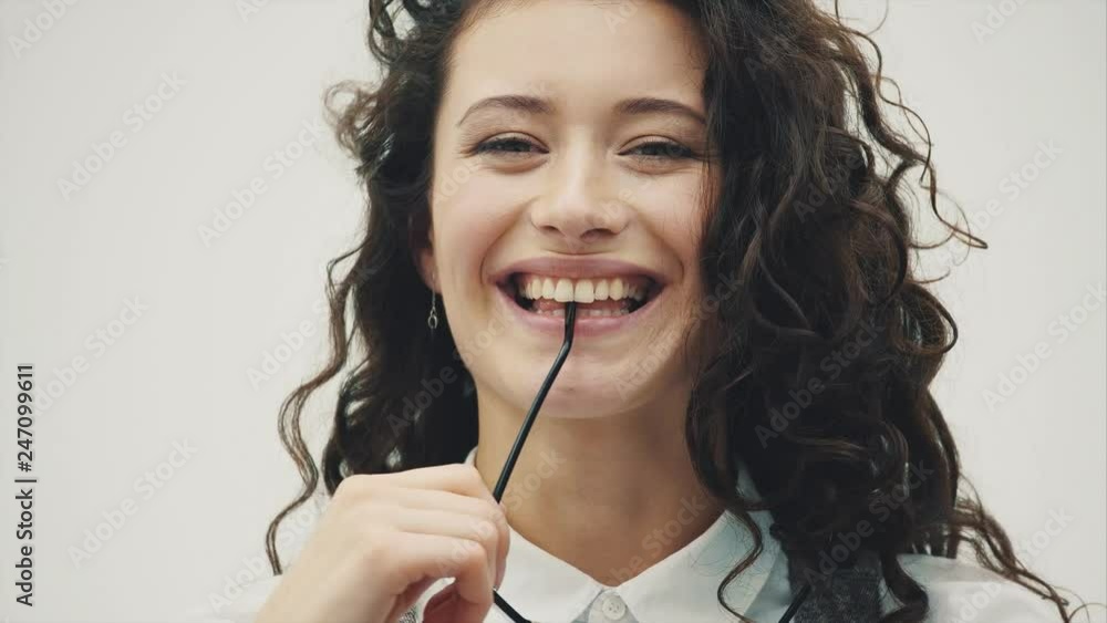 Close-up portrait of a surprised young beautiful brunette business woman. Mouth and eyes are opened in glasses, isolated on a white background. Close-up portrait of a surprised young beautiful brunette business woman. Mouth and eyes are opened in glasses, isolated on a white background.