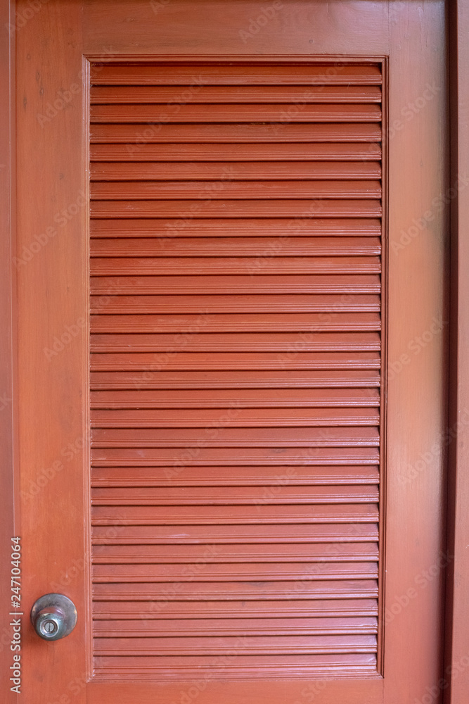 Close up of a modern brown/red wooden living room door