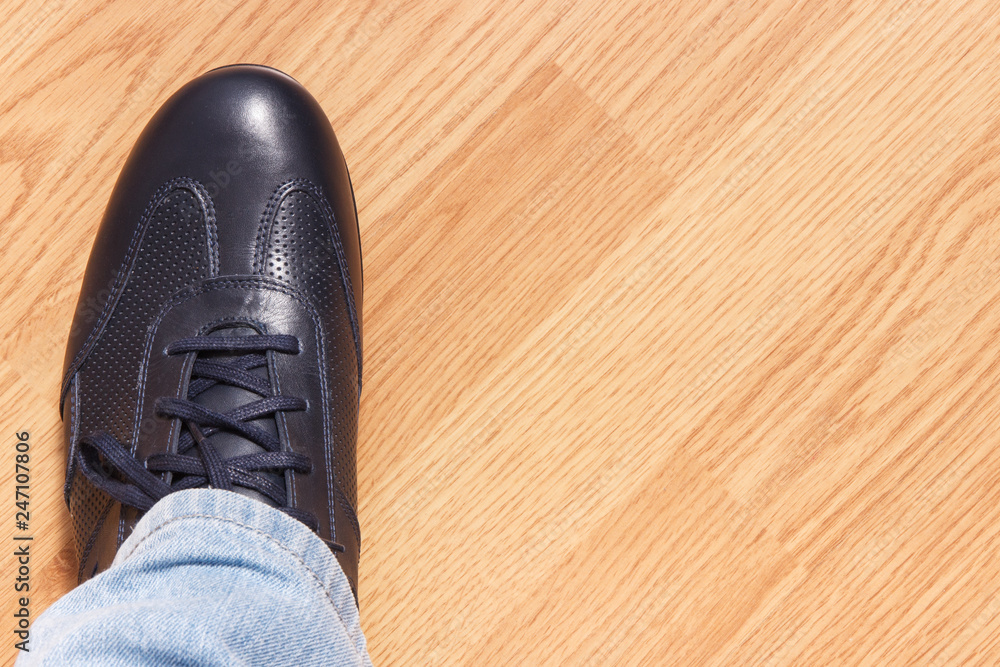 Navy blue leather shoe for men on wooden background, copy space for inscription