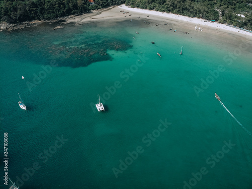 Aerial view of many anchoring yachts in open water. Ocean and sea travel and transportation..