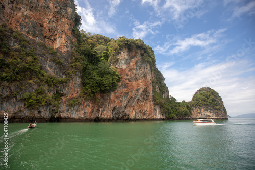 green sea and big mountains. Small boat and yacht in the sea. beautiful natural landscape. Andaman Sea, Krabi Thailand