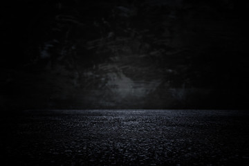 Spotlight over concrete floor. dark black background