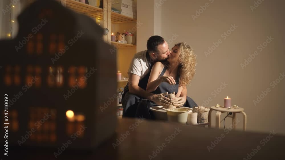 happy family on a creative joint vacation. bearded man and a young woman mold a vase in craft studio workshop, slow motion happy family on a creative joint vacation. bearded man and a young woman mold a vase in craft studio workshop, slow motion