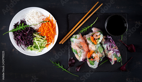 Vegetarian vietnamese spring rolls with spicy shrimps, prawns,  carrot, cucumber, red cabbage and rice noodle. Seafood. Tasty meal.  Top view, flat lay, copy space