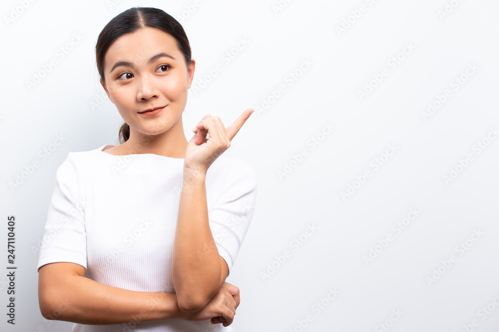 Happy woman is pointing to copy space isolated over white background Happy woman is pointing to copy space isolated over white background