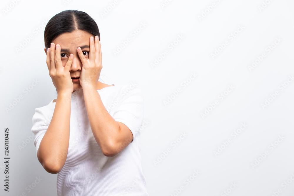 Scared woman standing isolated over white background Scared woman standing isolated over white background