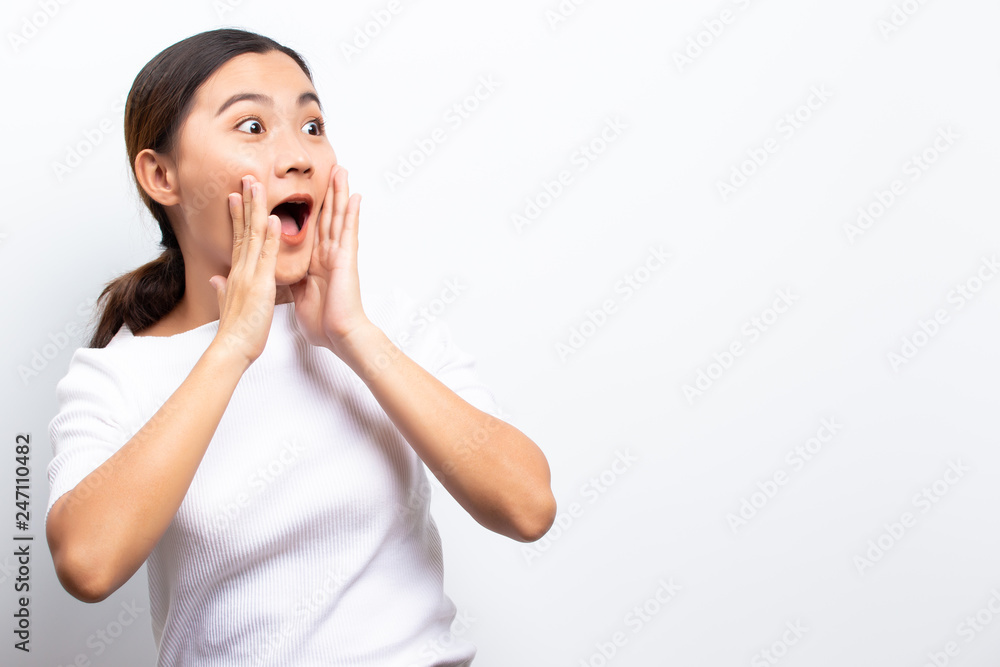 Happy woman has surprised and shouting to copy space isolated over white background Happy woman has surprised and shouting to copy space isolated over white background