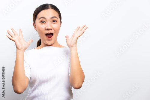 Happy woman with raised hands and celebrating standing isolated over white background