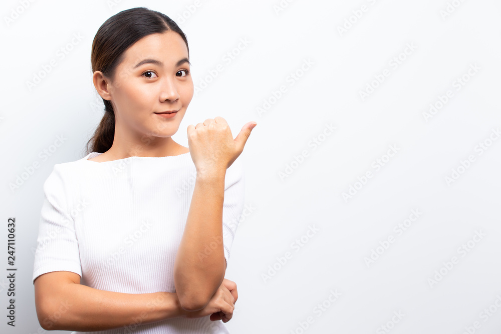 Happy woman is pointing to copy space isolated over white background Happy woman is pointing to copy space isolated over white background