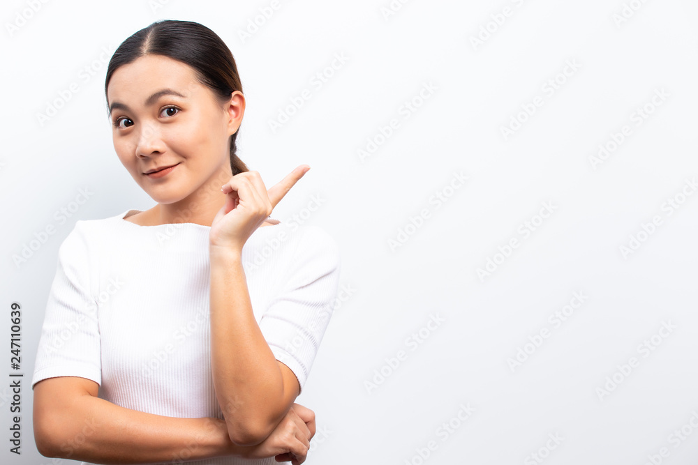 Happy woman is pointing to copy space isolated over white background Happy woman is pointing to copy space isolated over white background
