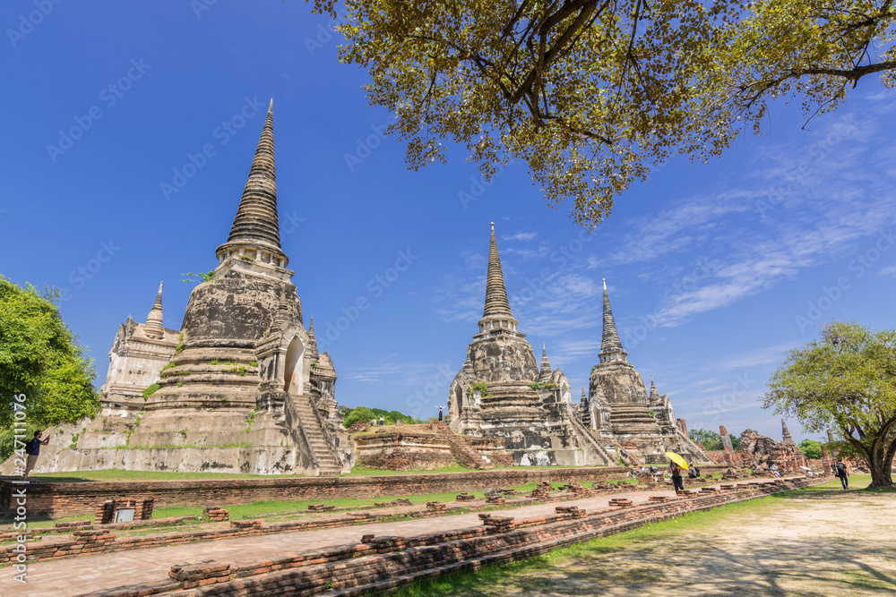 Tourist visit Pagoda and blue sky in Wat Phra Si Sanphet. The ancient temple of Ayutthaya Thailand.
