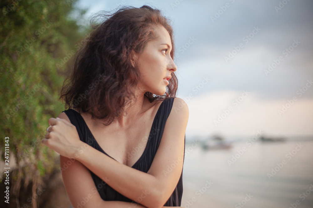 Portrait of a beautiful young woman with dark hair, on the beach, sensual portrait, natural beauty Portrait of a beautiful young woman with dark hair, on the beach, sensual portrait, natural beauty