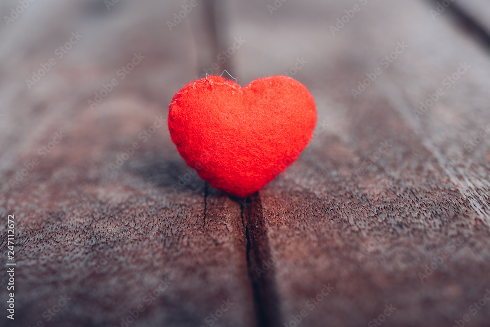 Fototapeta premium Red heart stand on wooden background,