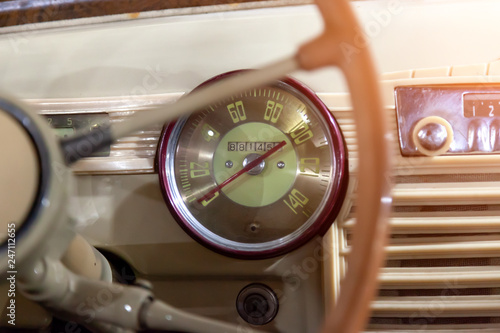 View from rear seat on the steering wheel and the interior of the old Russian car of the executive class released in the Soviet Union beige car © Aleksandr Kondratov