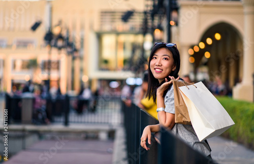Photography Girl with shopping bags in front of a mall