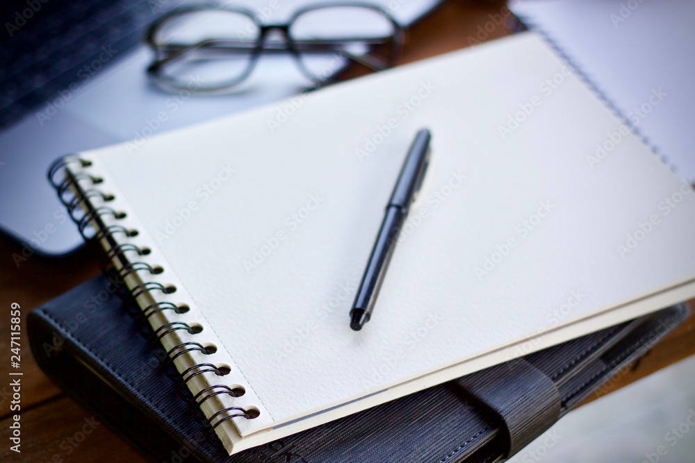 notebook and pen on wooden table notebook and pen on wooden table