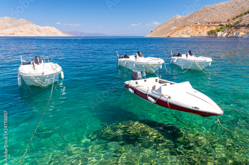 Fishing boats at the coast of Symi island, Greece © lukaszimilena
