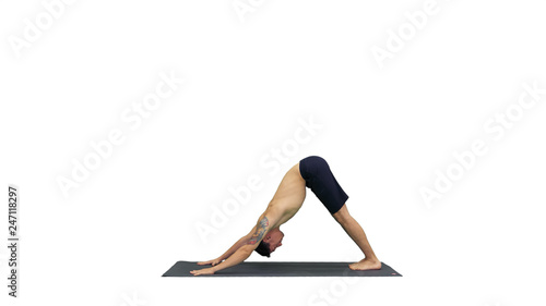 Profile of muscular handsome young man working out, standing in yoga upward, downward facing dog pose, then streching his arms on white background.