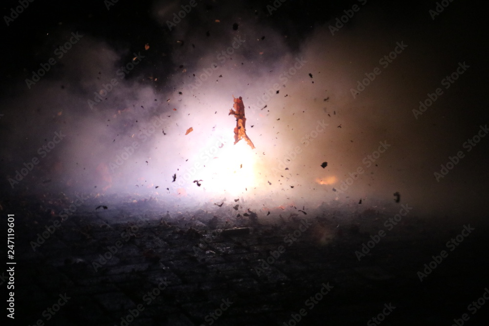 Fototapeta premium Hard chinese crackers in a row are exploding during New Years Eve in the Netherlands where this kind of fireworks are illegal