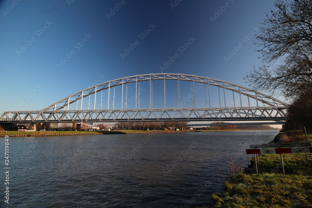 Bridge over canal named Amsterdam Rijnkanaal at Houten in the morning sun. This canal connects harbor of Amsterdam with river Rhine