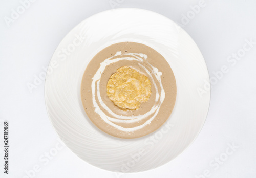 mushroom cream soup in the white plate, top view