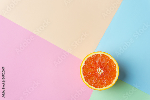 summer vacation, exotic tropical fruit minimal concept. creative layout of orange on multicolored background with copy space