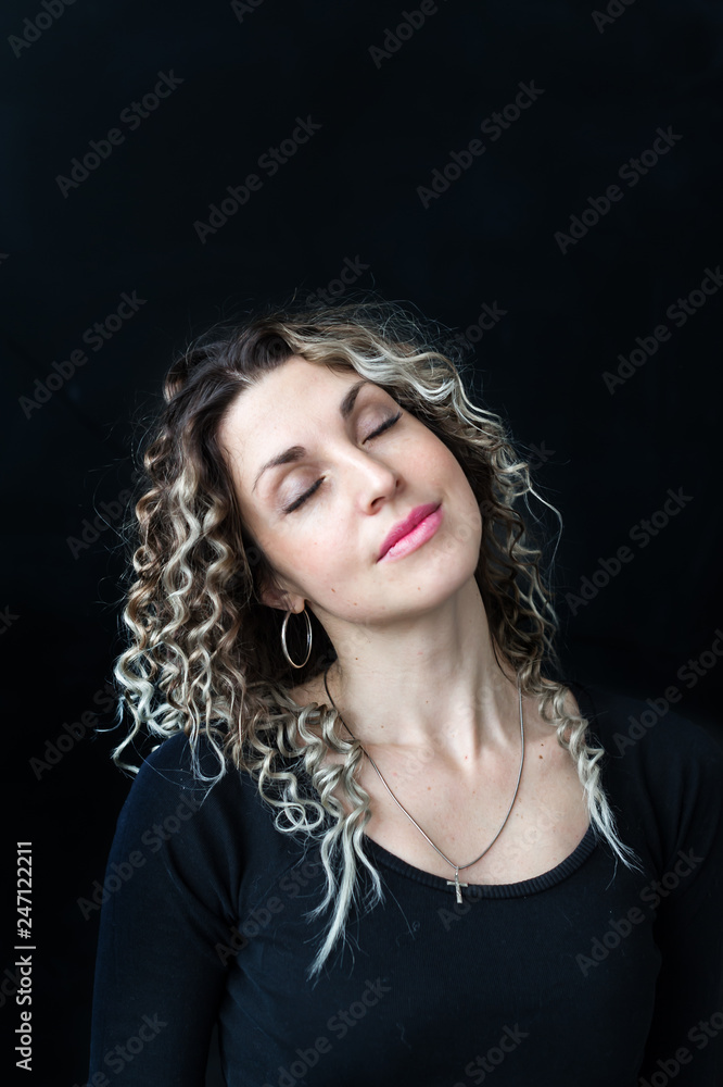 Fashion studio portrait of beautiful young woman on dark background Fashion studio portrait of beautiful young woman on dark background