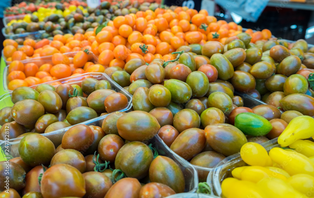 Assortment of different organics cherry tomatoes sold at local city market Assortment of different organics cherry tomatoes sold at local city market