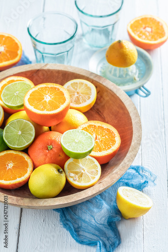 Sweet oranges, limes and lemons with on rustic table