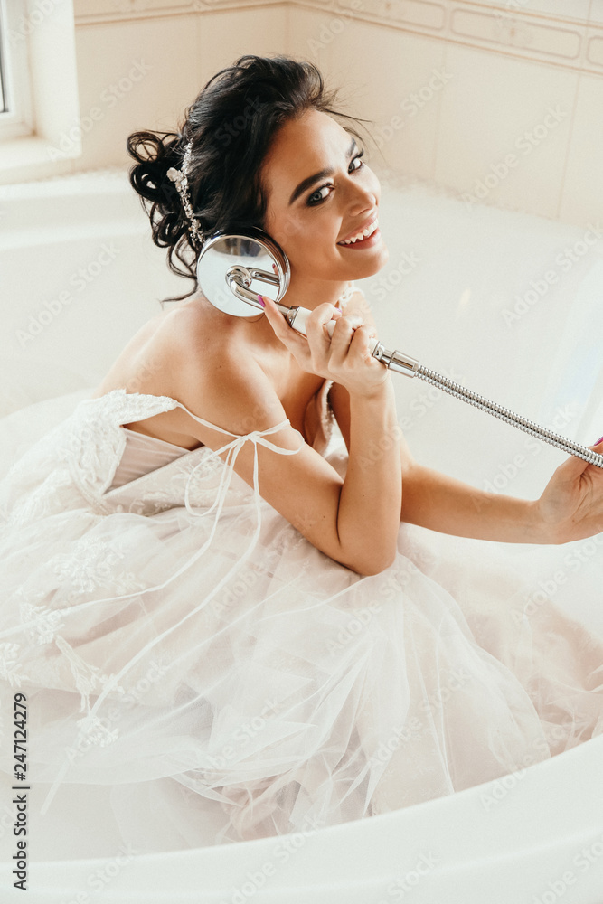 beautiful woman bride with dark hair in luxurious wedding dress posing in  bath Stock Photo | Adobe Stock