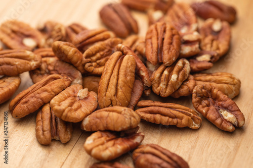 Dry pecan nuts on wooden table