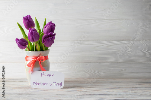 Woman's day background with lettering and fresh beautiful tulips bouquet