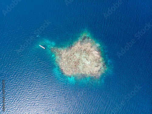 Aerial top down people snorkeling on coral reef tropical caribbean sea, turquoise blue water. Indonesia Wakatobi archipelago, marine national park, tourist diving travel destination