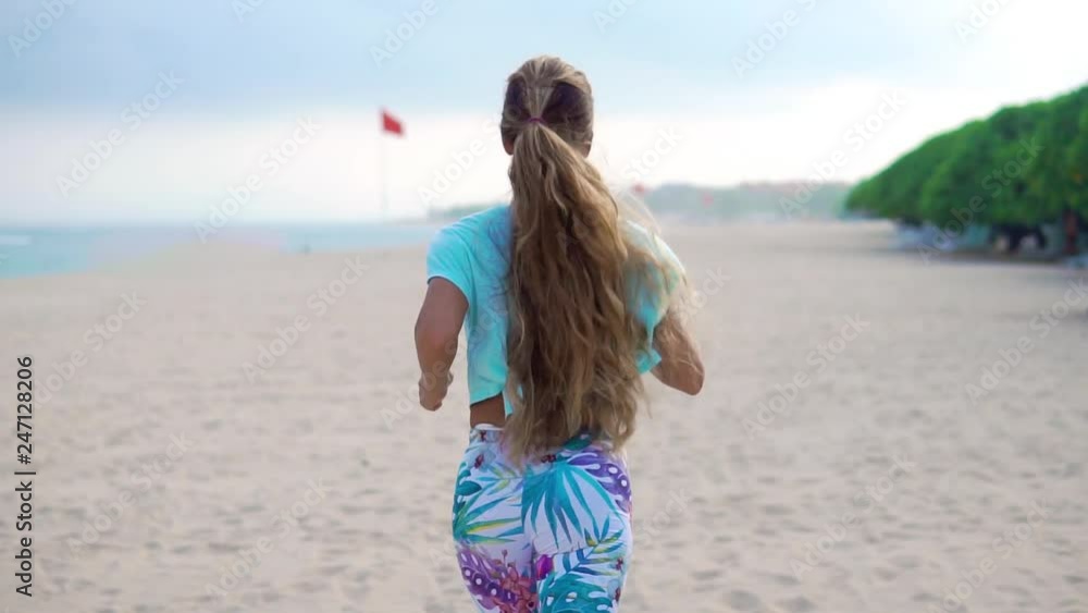 Woman running on beach at sunset. Beautiful fitness caucasian girl exercising outdoors on sea background. Caucasian fit model. Woman running on beach at sunset. Beautiful fitness caucasian girl exercising outdoors on sea background. Caucasian fit model.