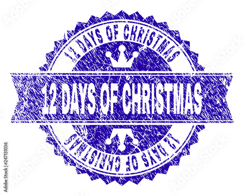 12 DAYS OF CHRISTMAS rosette stamp imprint with distress texture. Designed with round rosette, ribbon and small crowns. Blue vector rubber watermark of 12 DAYS OF CHRISTMAS label with dust texture.