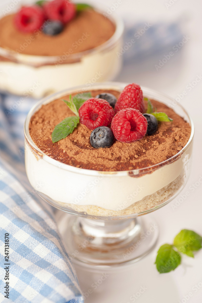 The popular Italian dessert tiramisu in a glass with fresh berries The popular Italian dessert tiramisu in a glass with fresh berries