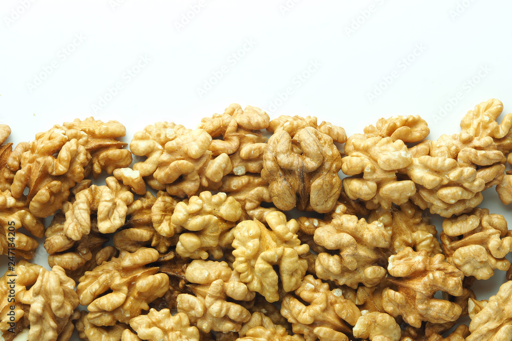 Walnuts as a background and texture on a white background Walnuts as a background and texture on a white background