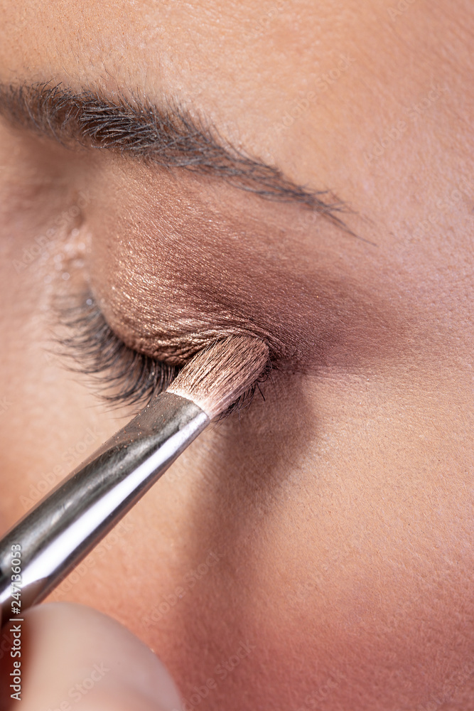 sexy girl putting mascara on eyelashes.beauty make up