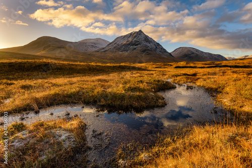 Golden Morning Light At Rannoch Moor With Snowcapped Scottish Mountains.