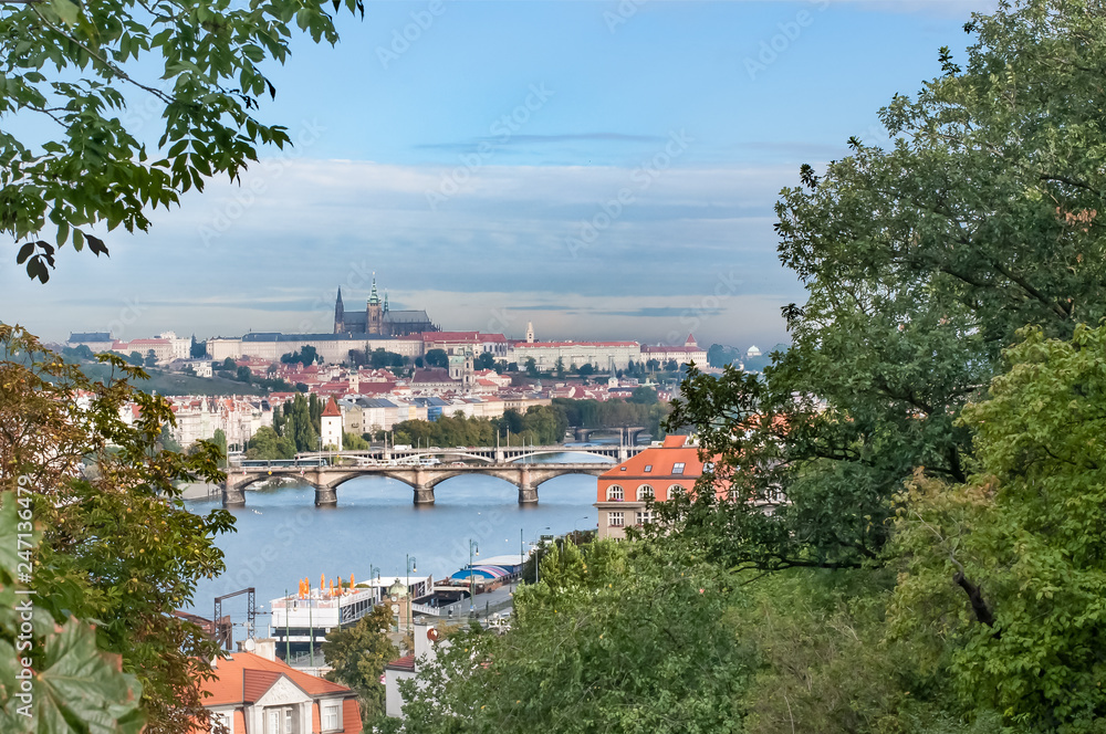 View of bridges, river, castle church in Prague, Czech Republic.