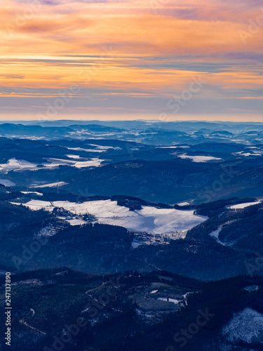 Blick über die Berge mit Schnee und Sonnenuntergang