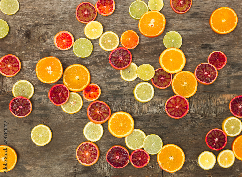 many different juicy and healthy citrus fruits lie together on an old, vintage wood background many different juicy and healthy citrus fruits lie together on an old, vintage wood background